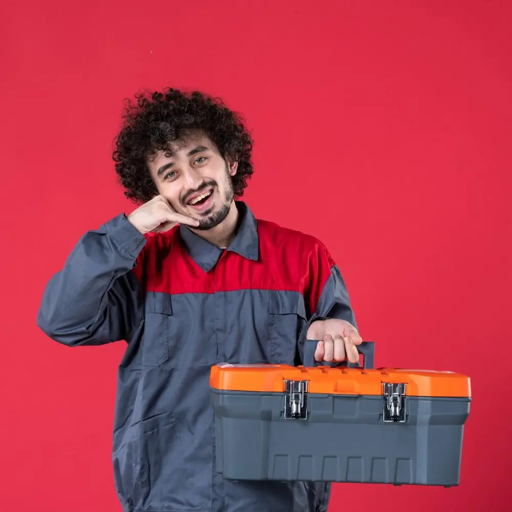 Front View Young Male Worker Uniform with Tool Case Red Surface